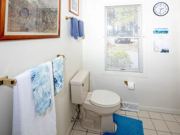 a white toilet sitting next to a bathroom sink