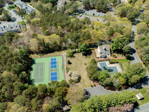 an aerial view of a house with a yard