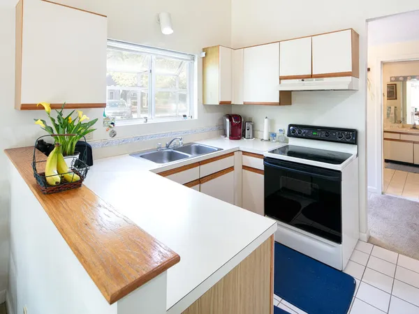 a kitchen with stainless steel appliances granite countertop a sink a stove and a microwave