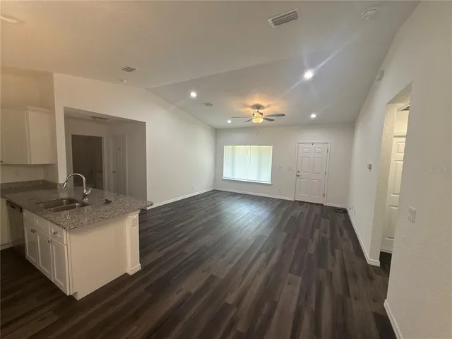 a view of a kitchen cabinets a sink and wooden floor