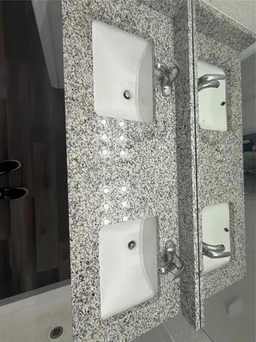 a view of a kitchen with wooden floor and a window
