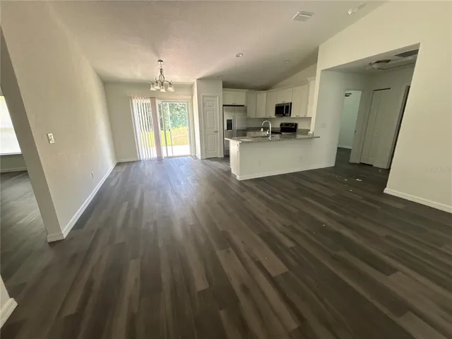 a kitchen with wooden floors and white walls