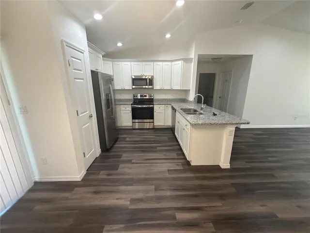 a kitchen with stainless steel appliances a refrigerator and a sink