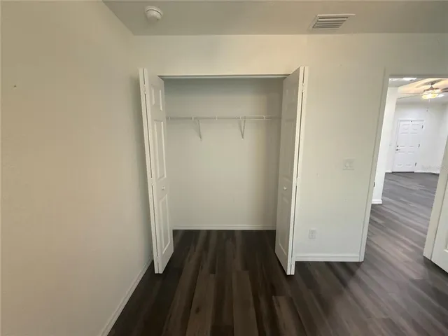 a view of a room with wooden floor and a sink