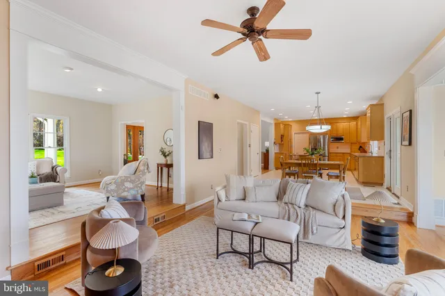 a living room with furniture and a large window with wooden floor