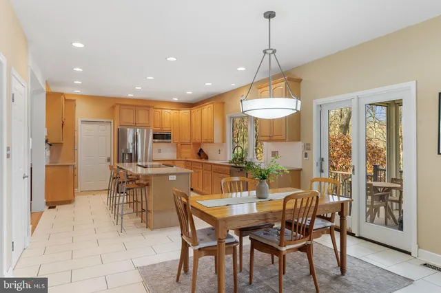 a large kitchen with kitchen island a sink appliances and a counter space