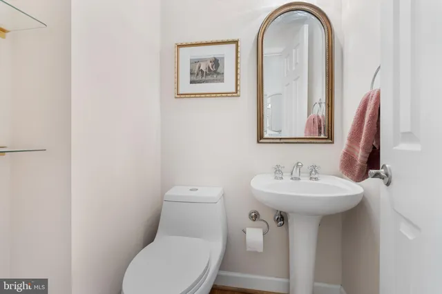 a bathroom with a granite countertop double vanity sink mirror and window
