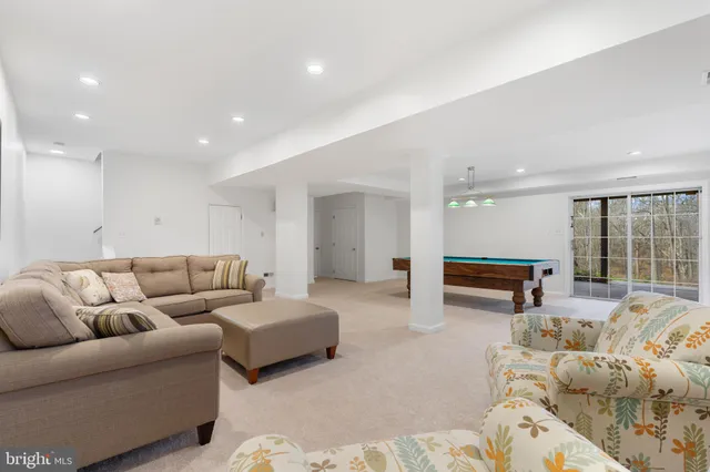 a dining room with furniture window and wooden floor