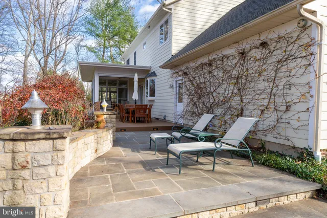 a aerial view of a house with swimming pool next to a yard