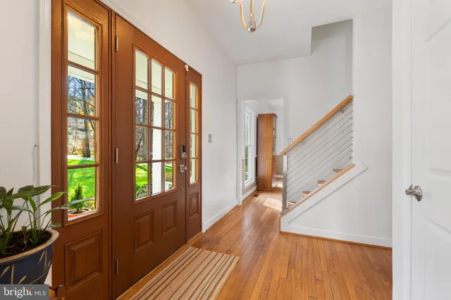 a living room with furniture wooden floor and a large window