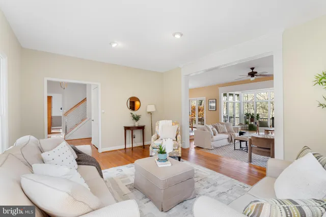 a living room with furniture a fireplace and a floor to ceiling window