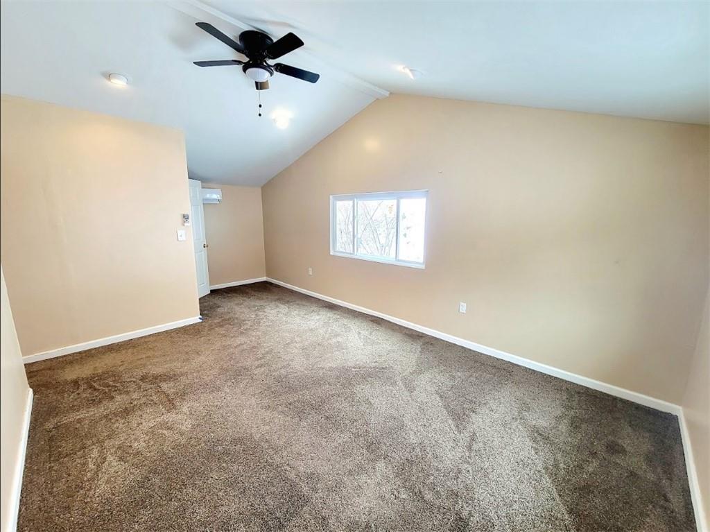 710 Parkwood Road Pittsburgh, PA 15210 - Photo 9 of 17 an empty room with a ceiling fan and windows