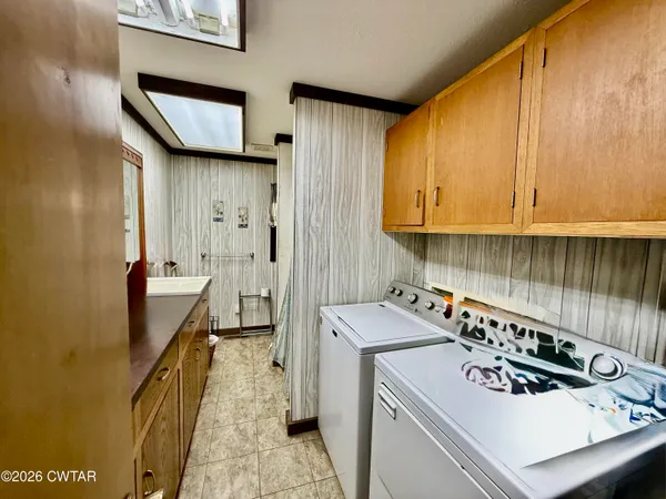 a utility room with sink dryer and washer