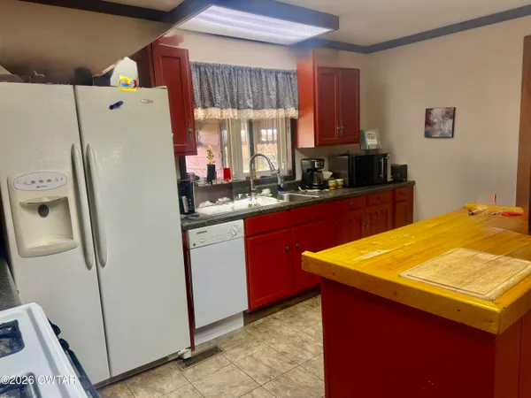 a white refrigerator freezer sitting inside of a kitchen