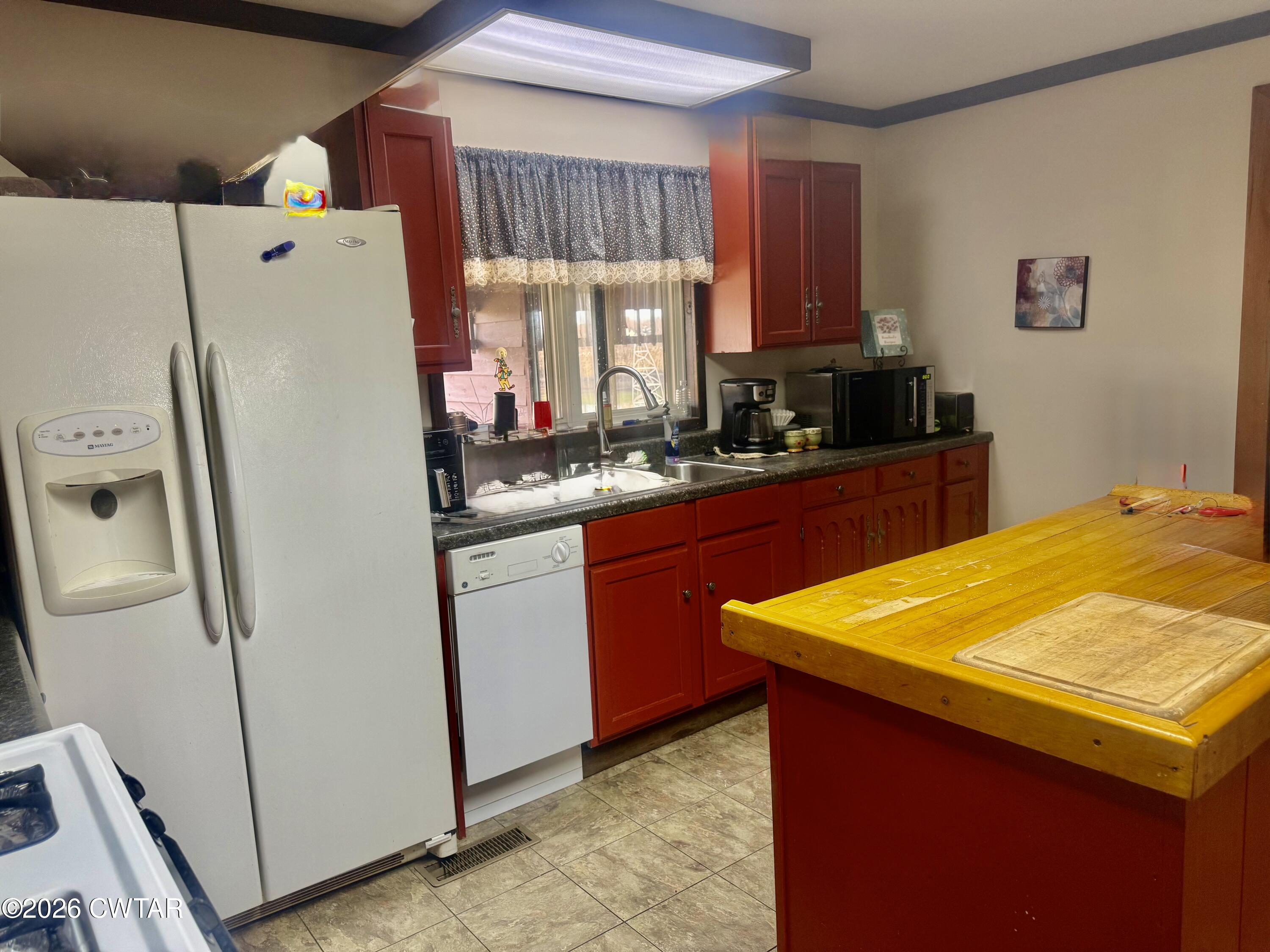 5082 Claude Tucker Road Union City, TN 38261 - Photo 7 of 20 a white refrigerator freezer sitting inside of a kitchen
