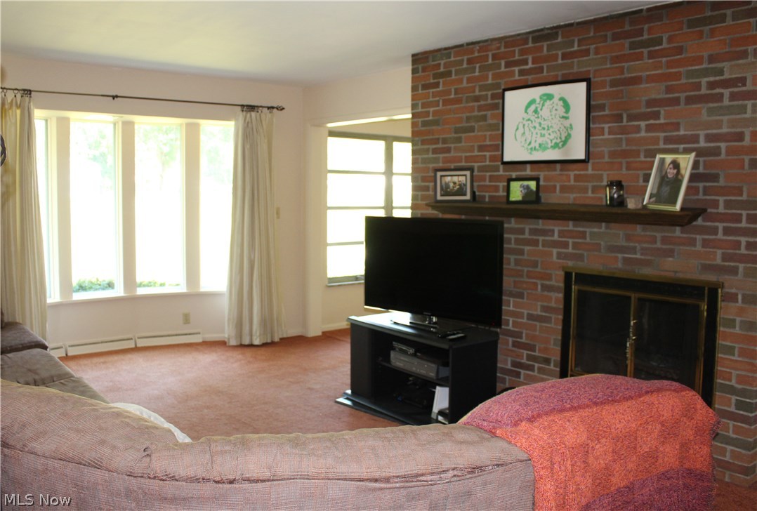 1825 Walnut Road Kent, OH 44240 - Photo 4 of 23 The living room sports a bayed window overlooking the backyard, and a wood-burning fireplace that is 2-sided into the adjacent dining room.