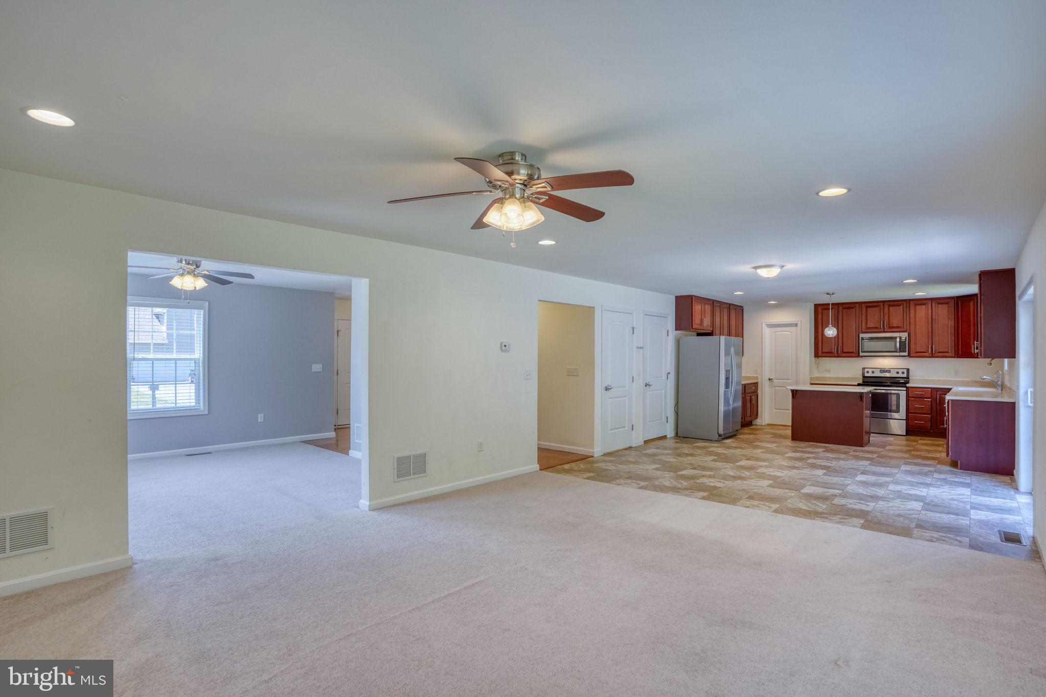 107 Hunters Run Magnolia, DE 19962 - Photo 12 of 41 a view of a livingroom with a ceiling fan a ceiling fan and a kitchen