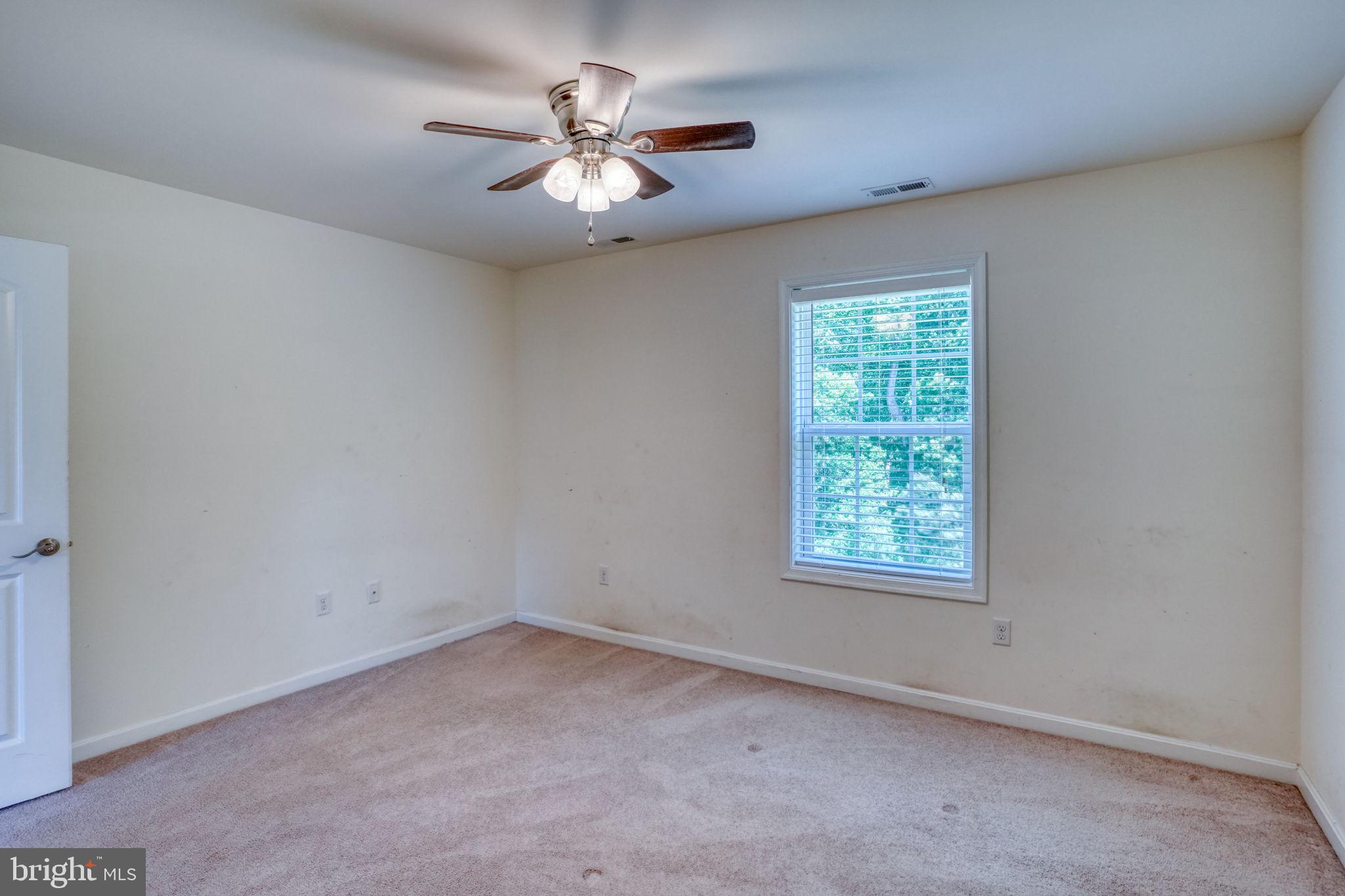 107 Hunters Run Magnolia, DE 19962 - Photo 27 of 41 an empty room with a chandelier fan and windows