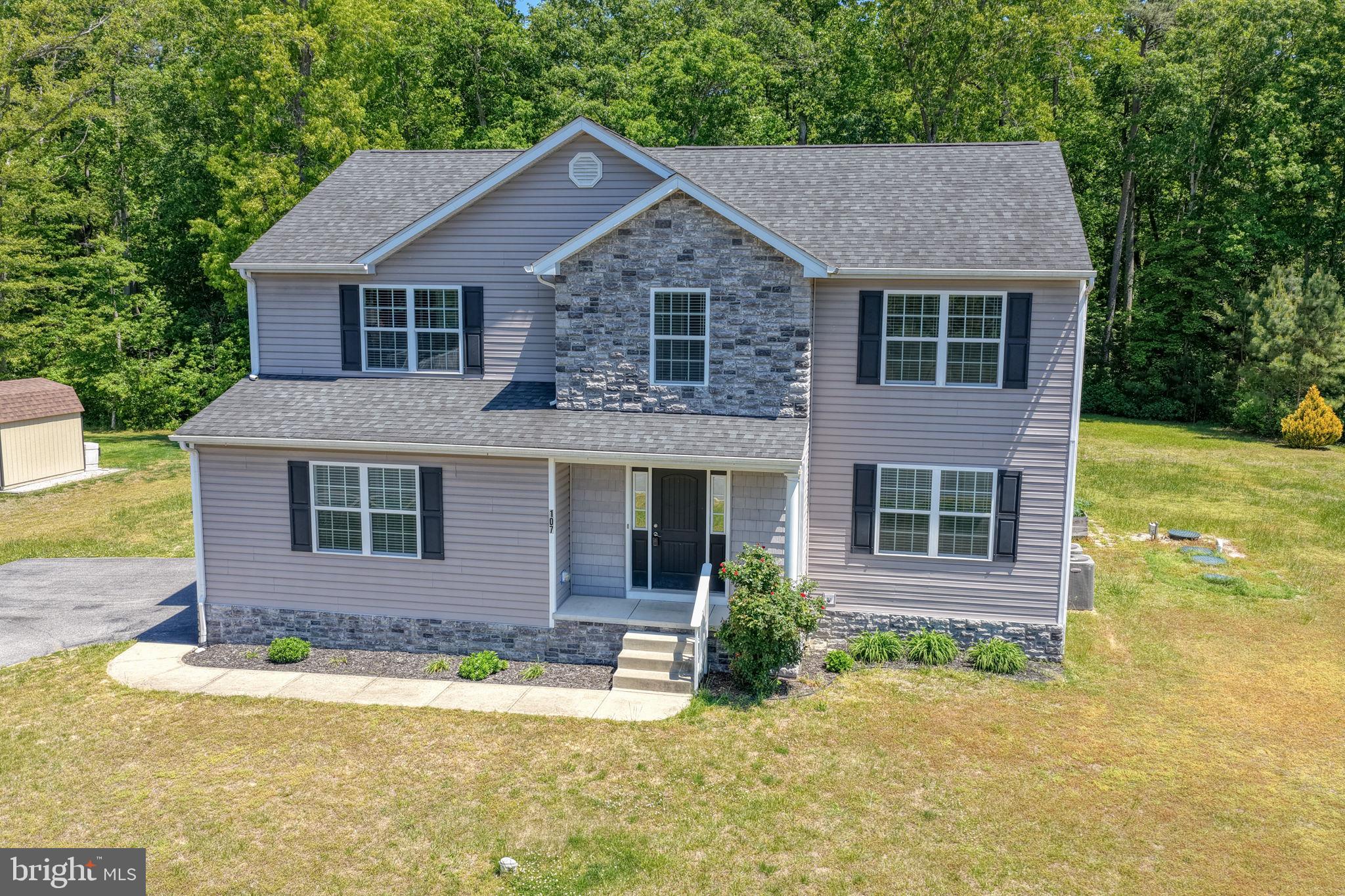 107 Hunters Run Magnolia, DE 19962 - Photo 30 of 41 a front view of a house with a yard and garage