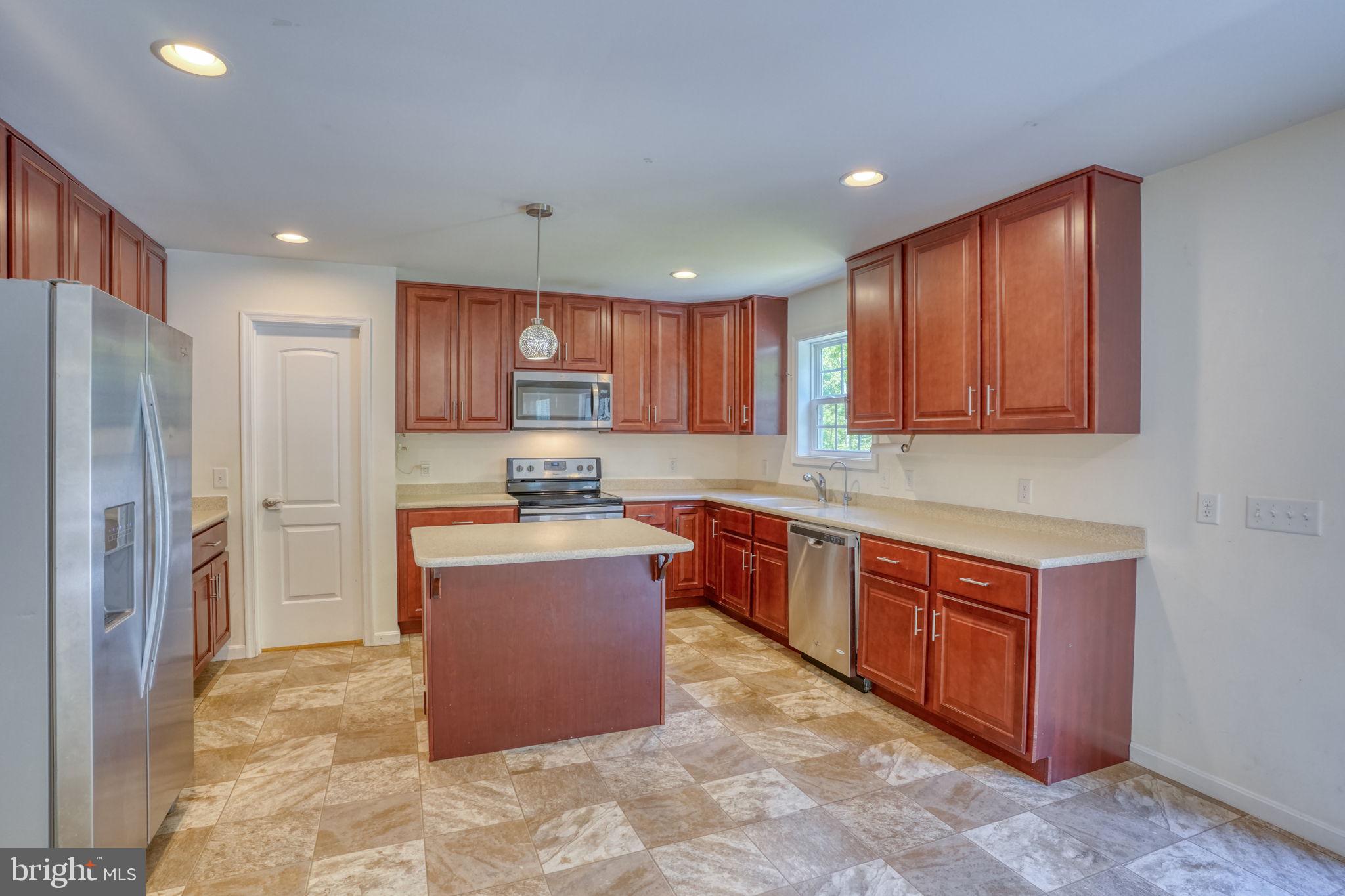 107 Hunters Run Magnolia, DE 19962 - Photo 3 of 41 a kitchen with stainless steel appliances granite countertop a stove refrigerator a sink and dishwasher