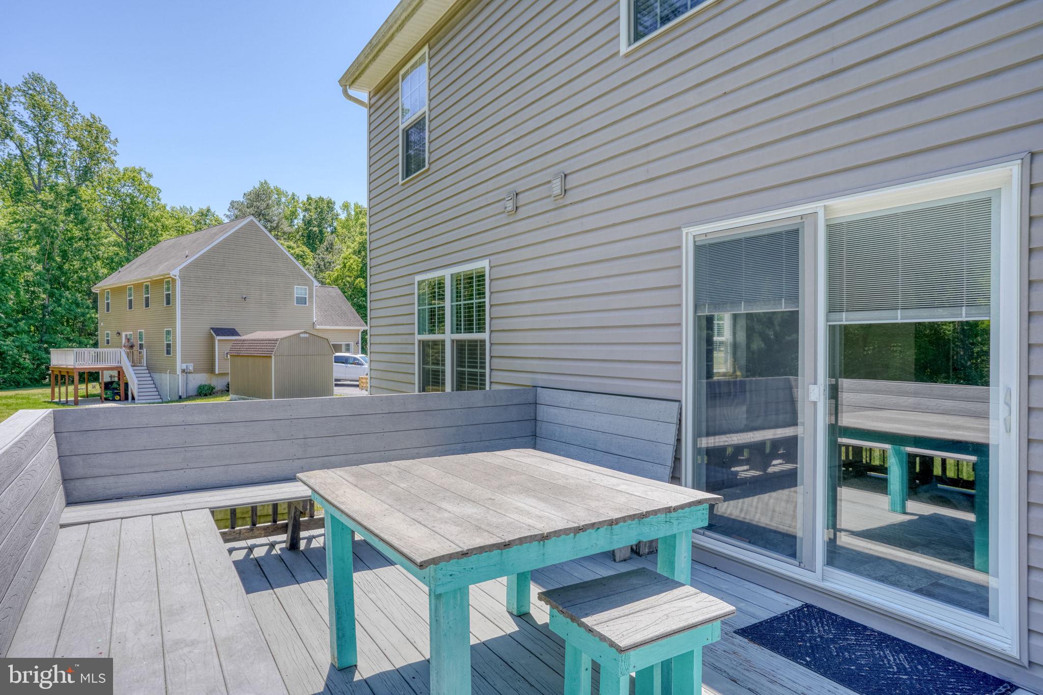 107 Hunters Run Magnolia, DE 19962 - Photo 36 of 41 a view of a patio with table and chairs with wooden floor and fence and a potted plant