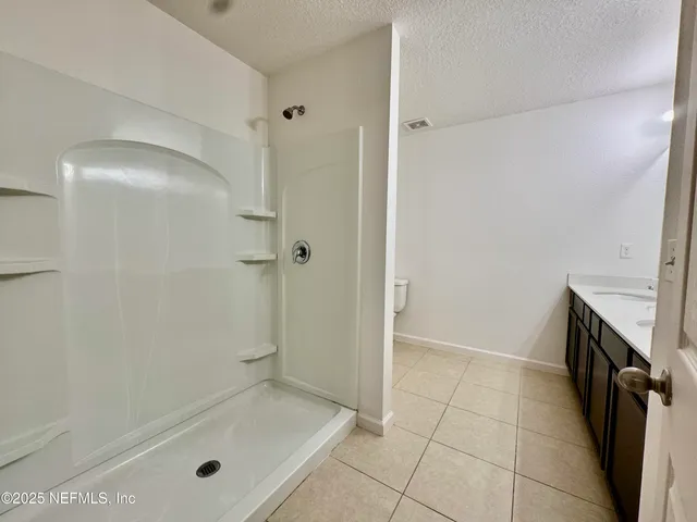 a bathroom with a tub a sink and a shower