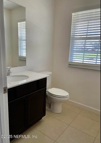a bathroom with a sink a toilet and a window