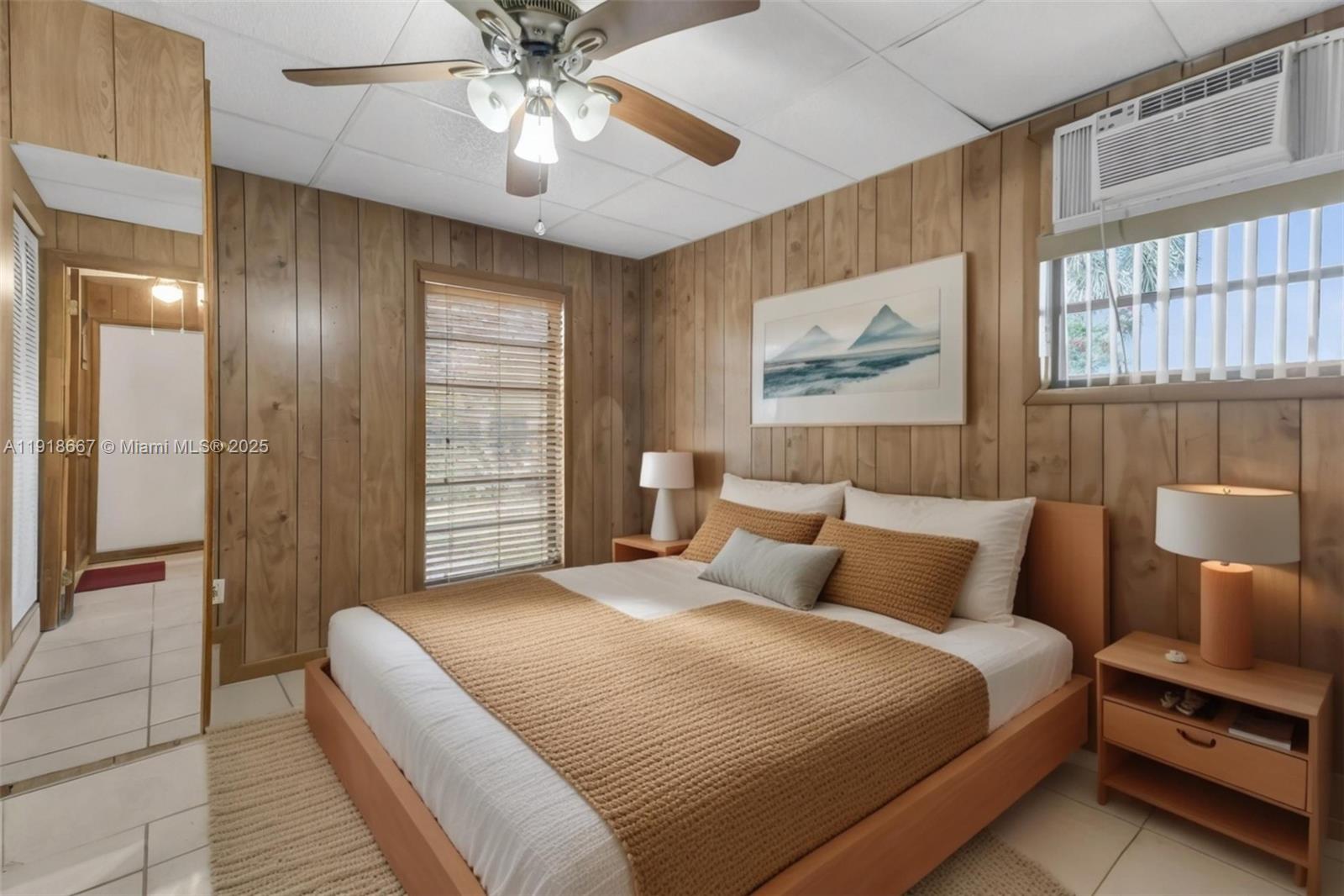 16001 Southwest 98th Avenue Miami, FL 33157 - Photo 15 of 22 a bedroom with a large bed and a chandelier