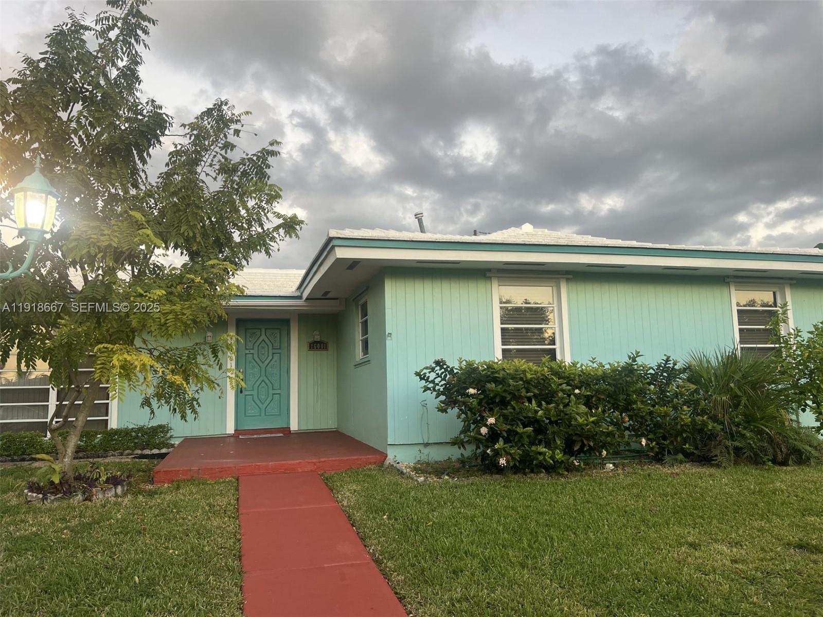 16001 Southwest 98th Avenue Miami, FL 33157 - Photo 2 of 22 a front view of a house with garden