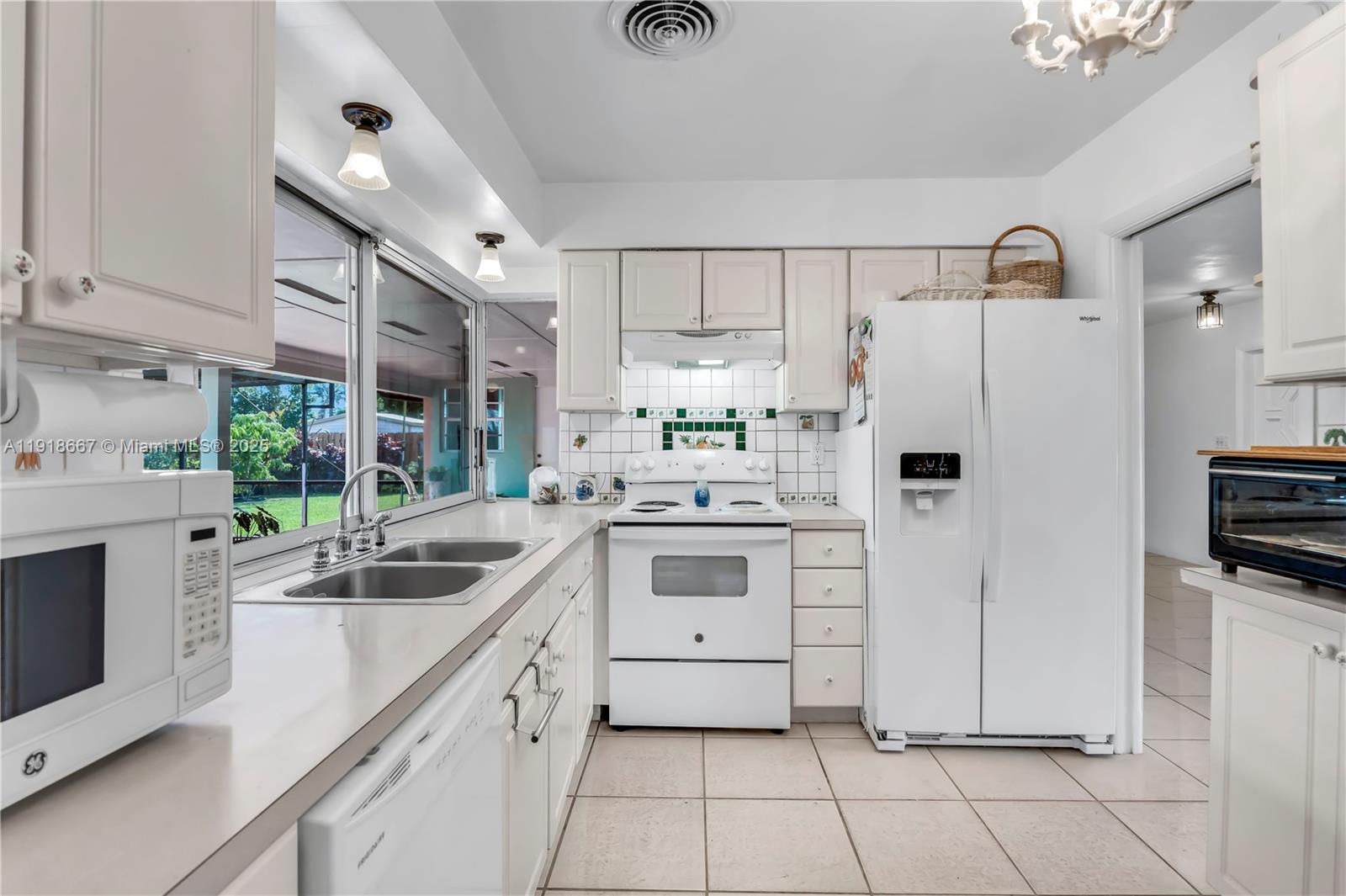 16001 Southwest 98th Avenue Miami, FL 33157 - Photo 6 of 22 a kitchen with white cabinets and white appliances