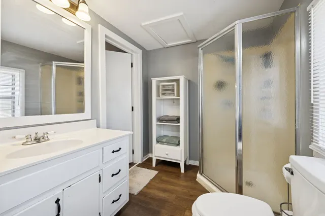a bathroom with a sink toilet and shower