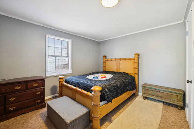 a bedroom with a bed and window