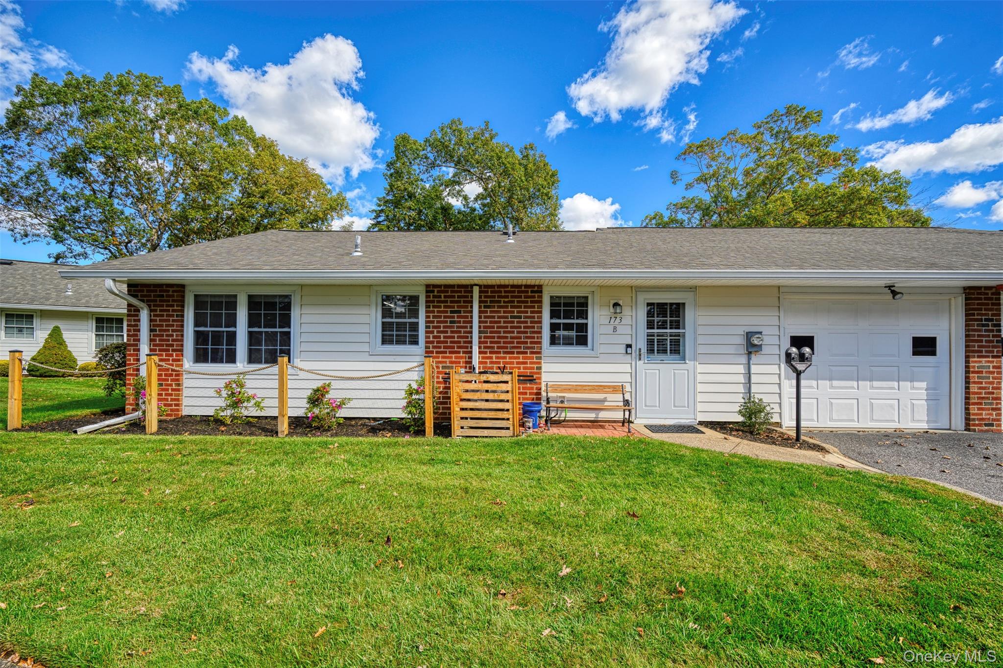 173 Ventry Court Ridge, NY 11961 - Photo 1 of 1 a front view of a house with a yard and garage