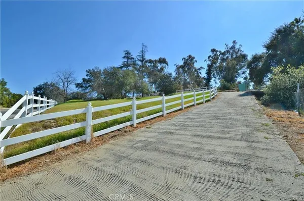 a view of a yard with iron fence