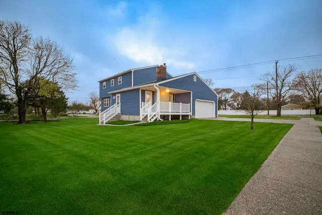 a front view of house with yard and green space