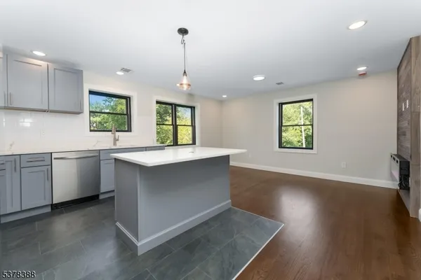 a kitchen with stainless steel appliances a refrigerator sink and stove