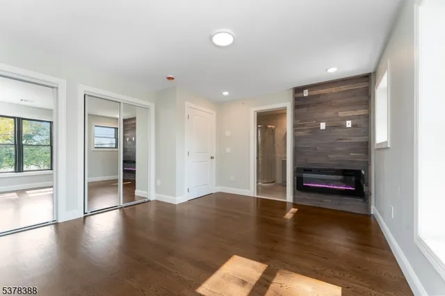 a large kitchen with stainless steel appliances granite countertop a sink a stove and a refrigerator