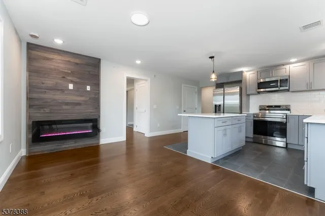 an empty room with wooden floor and a window