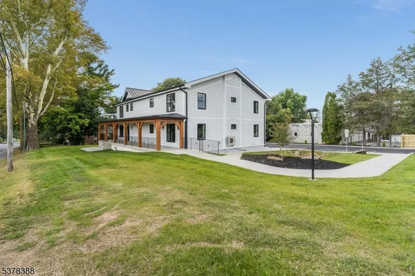 a view of a house with swimming pool and a yard