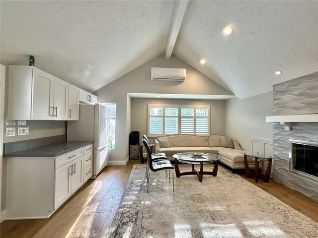a outdoor kitchen with a stove and white cabinets