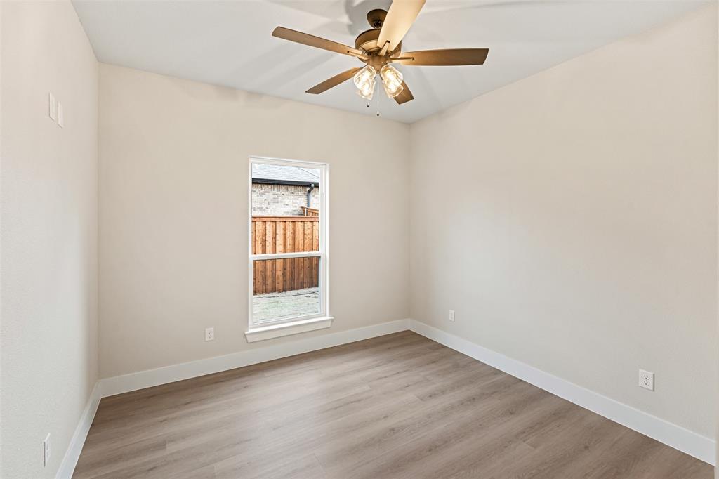 506 Limestone Circle Mabank, TX 75147 - Photo 21 of 33 an empty room with a window and a fan