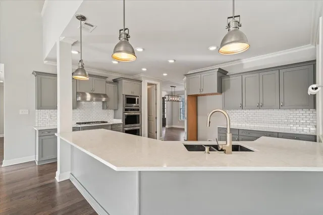 a kitchen with stainless steel appliances a sink and a refrigerator