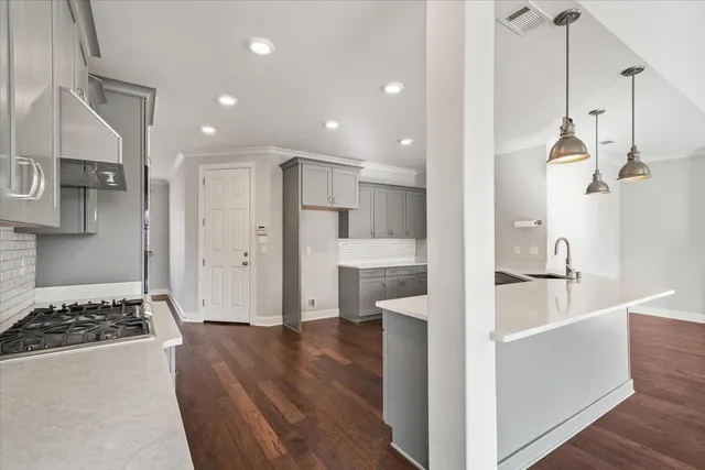a large kitchen with a sink and a refrigerator