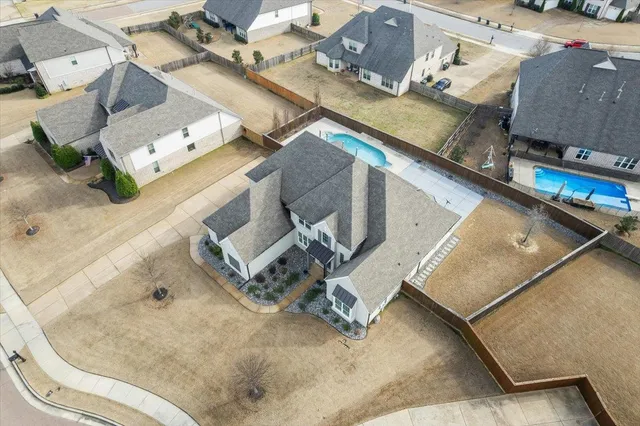 an aerial view of a house with a yard