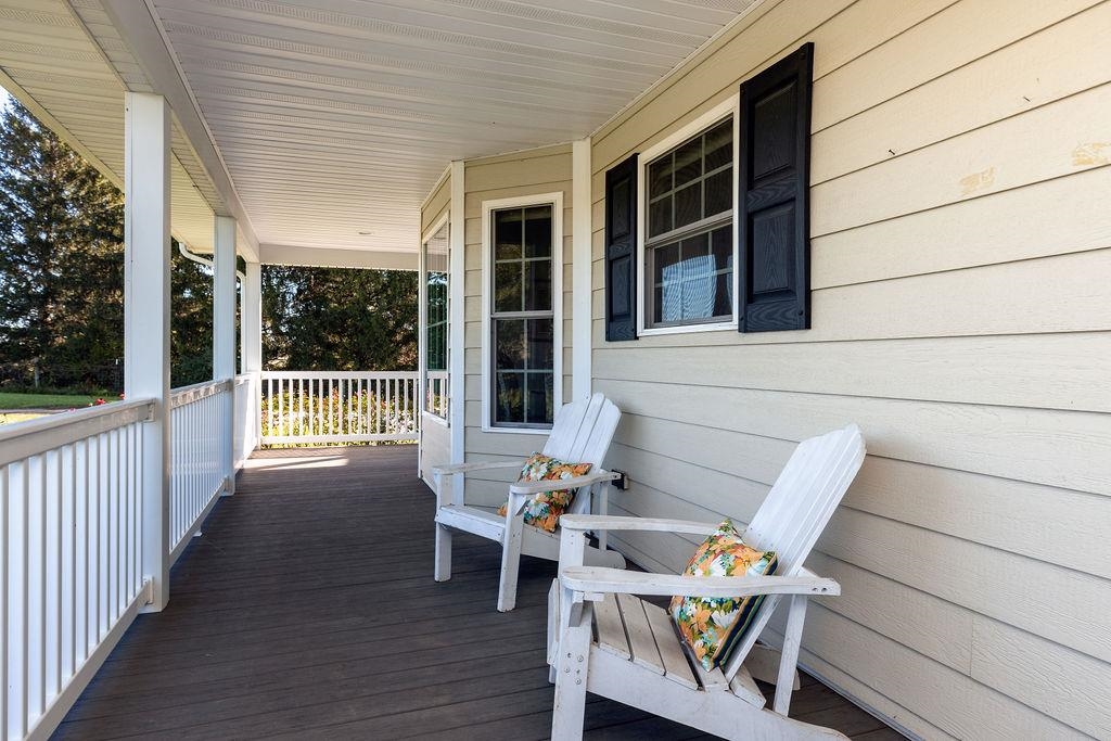 1401 Guthrie Road Stuarts Draft, VA 24477 - Photo 14 of 71 a view of a patio with table and chairs and wooden floor