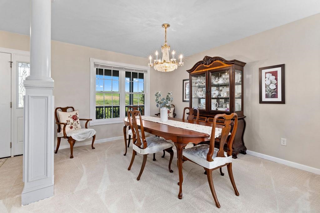 1401 Guthrie Road Stuarts Draft, VA 24477 - Photo 24 of 71 a dining room with furniture a chandelier and a rug