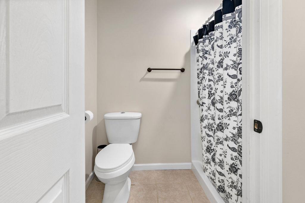1401 Guthrie Road Stuarts Draft, VA 24477 - Photo 36 of 71 a bathroom with a toilet and a shower curtain