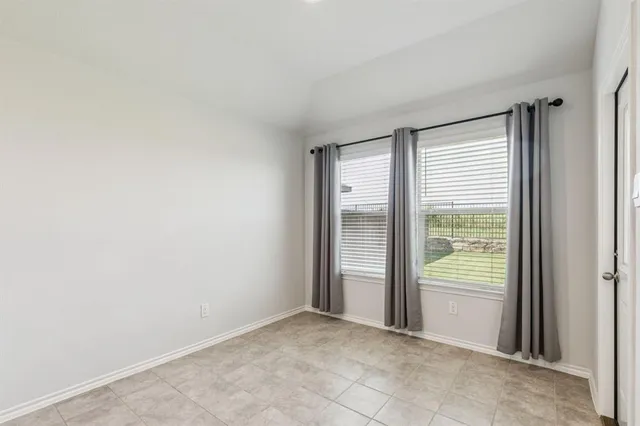 a kitchen with granite countertop white cabinets and stainless steel appliances