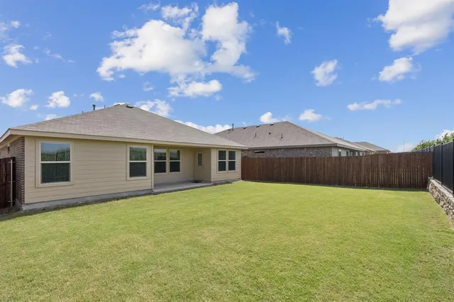 a backyard of a house with large trees