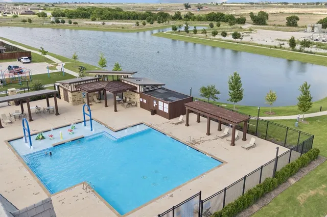 a view of a park with a slide and potted plants
